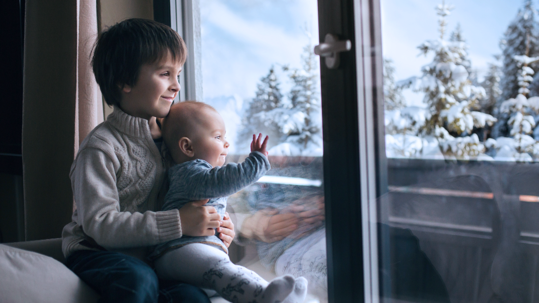 Children looking out window during the Winter