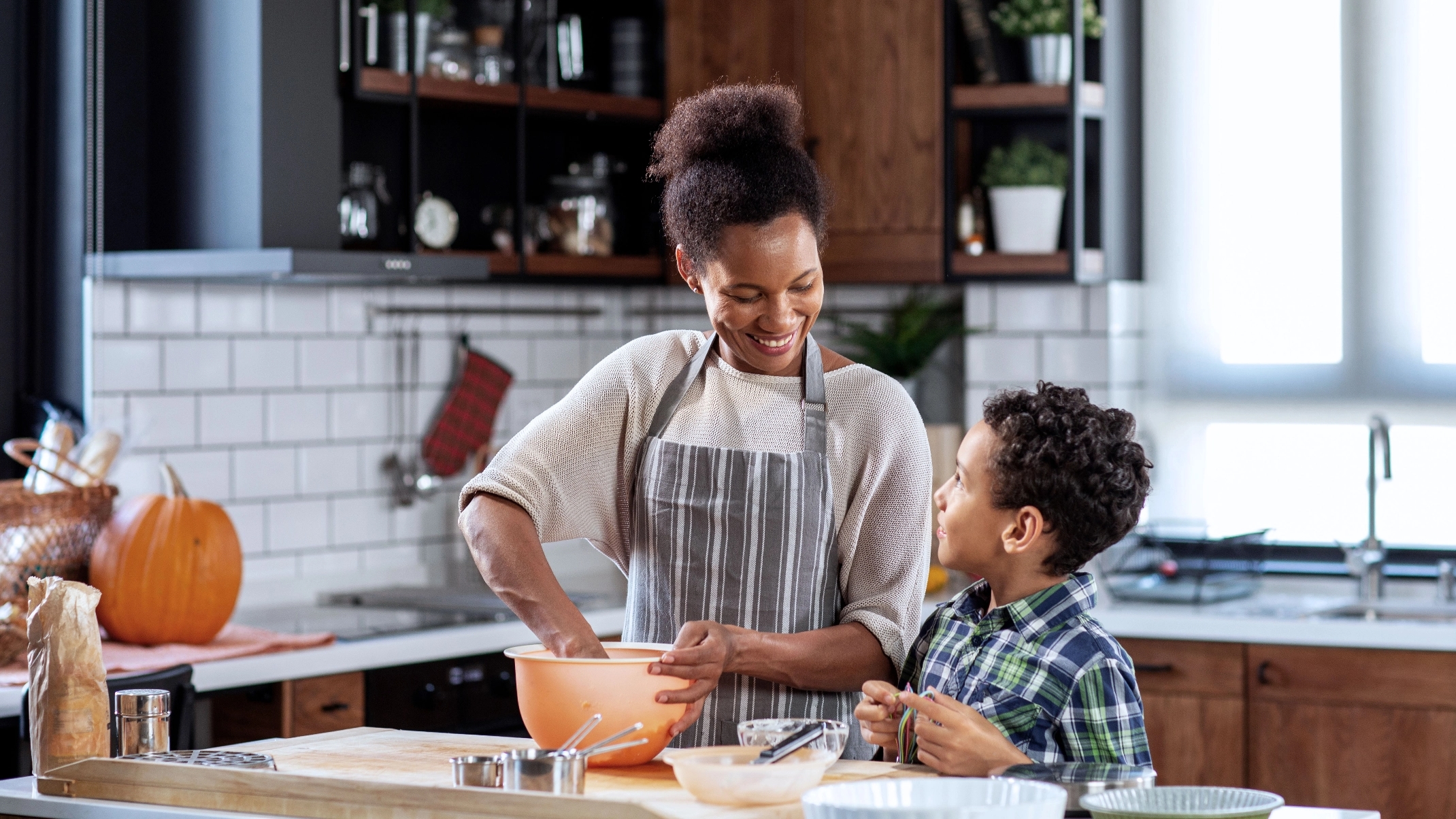 Mother cooking in kitchen with her son